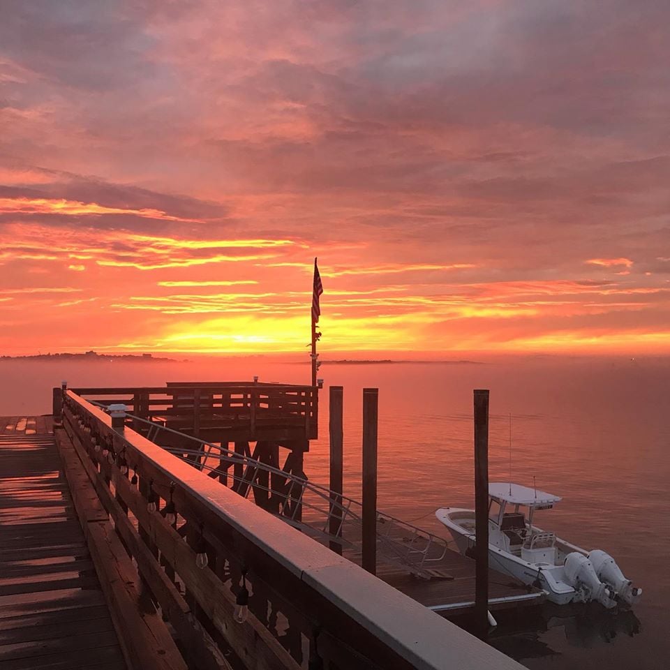 House Island sunsets are spectacular. This picture shows our commercial grade pier and docks and a double engined center console lit by a yellow orange fired sky.